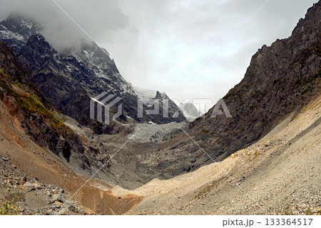 Chalaadi Glacier, ice, glacial flour, moraine, and snow in the Caucasus Mountains. Mestia, Svaneti, Georgia. 133364517