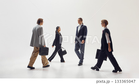 Stylish business professionals walking toward each other symbolizing connection and cooperation Stylish business professionals walking toward each other symbolizing connection and cooperation 133365047