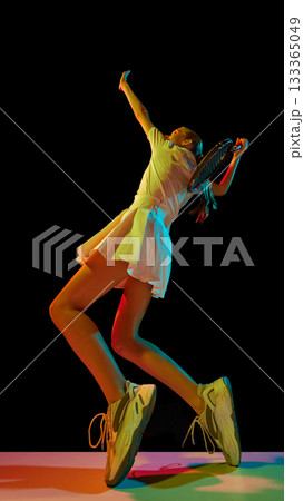 Female tennis player serving ball with emotion and physical intensity 133365049