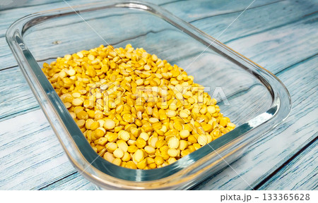 Split Chickpea Also Know as Chana Dal, Dried Chickpea Lentils in Glass Container on Wooden Background 133365628