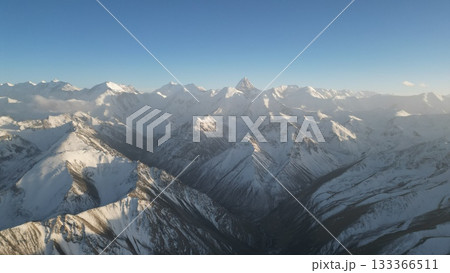 Snow-capped mountain range under clear blue sky with dramatic peaks Snow-capped mountain range under clear blue sky with dramatic peaks 133366511