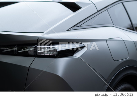 Modern car rear section closeup with sleek LED taillight design and matte gray finish. Modern car rear section closeup with sleek LED taillight design and matte gray finish. 133366512