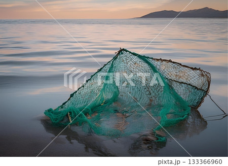 Green ghost net abandoned on beach at calm sunset. AI Generated 133366960