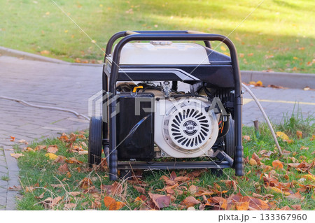 Diesel power generator. Business use mobile generator. Outdoor power supply generator placed in city in sunny day. Energy independence. Diesel power generator. Business use mobile generator. Outdoor power supply generator placed in city in sunny day. Energy independence. 133367960