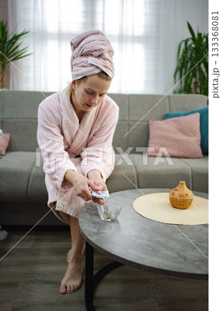 Woman putting money in a bowl of water for manifestation ritual at home 133368081