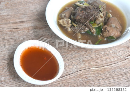 boiled braised beef meat and tendon couple organ in herb brown soup on bowl dipping spicy chili sauce boiled braised beef meat and tendon couple organ in herb brown soup on bowl dipping spicy chili sauce 133368382