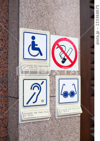 Set of disability icons, including wheelchair, deaf people and blind person. Hearing aid and problems with eyes. Signs at entrance to building for people with disabilities next to no smoking sign Set of disability icons, including wheelchair, deaf people and blind person. Hearing aid and problems with eyes. Signs at entrance to building for people with disabilities next to no smoking sign 133368675
