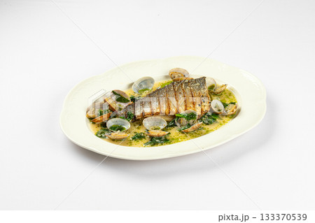 Grilled fish fillet with clams in herb sauce 133370539