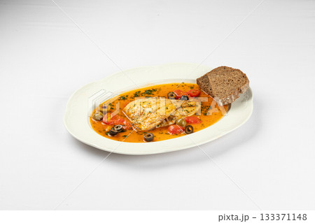Warm fish fillet in vegetable broth with bread 133371148
