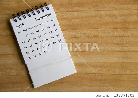 Top view of December 2025 calendar on wooden table. Year end concept. 133371503