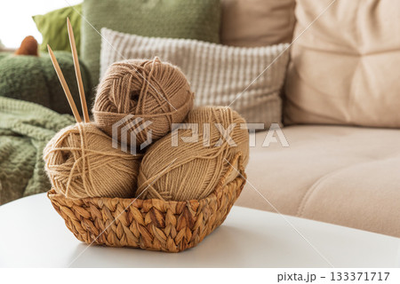 Basket with Yarn Balls on White Table in Cozy Living Room Basket with Yarn Balls on White Table in Cozy Living Room 133371717