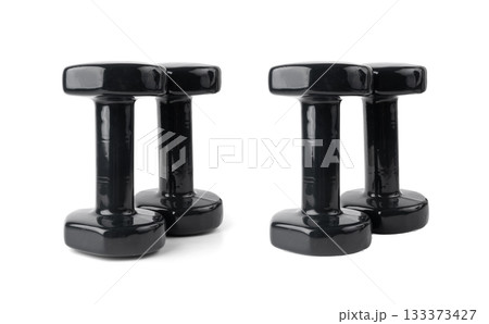 Two black dumbbells isolated. Rubberized heavy dumbbells for fitness, sport, weight exercises 133373427