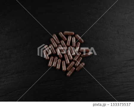 Iron capsule, Fe pills, dark red hemoglobin supplement tablets, vitamin capsules, mineral 133373537