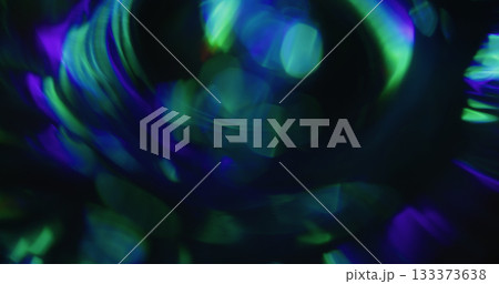 Bokeh light. Colorful leak. Blue green defocused circles flow on dark black background. Spectrum vivid reflection abstract texture. Bokeh light. Colorful leak. Blue green defocused circles flow on dark black background. Spectrum vivid reflection abstract texture. 133373638