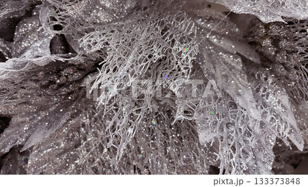 Abstract macro of silver glittery mesh fabric. Frozen lace Christmas decoration texture background 133373848