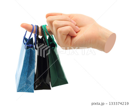 Hand holds mini shopping bag, isolated on transparent background, shopping concept. Contemporary art design Hand holds mini shopping bag, isolated on transparent background, shopping concept. Contemporary art design 133374219