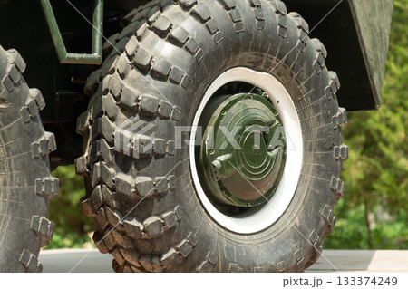Close-up of BTR-60 armored vehicle wheels, showing massive tires, rims, and suspension elements Close-up of BTR-60 armored vehicle wheels, showing massive tires, rims, and suspension elements 133374249