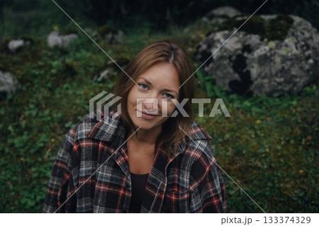 gentlehaired woman relaxing on verdant stone surrounded by rural tranquility and simplicity gentlehaired woman relaxing on verdant stone surrounded by rural tranquility and simplicity 133374329
