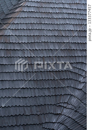 shingles on the roof. Wooden roof, shingled roof. Wooden tile. Roof of complex construction with dormer windows 133377457