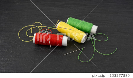 Needle and thread. Needlework object, color cotton thread spool and needle 133377889