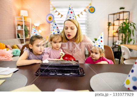 Celebrating a joyful birthday with laughter and cake by young friends Celebrating a joyful birthday with laughter and cake by young friends 133377929