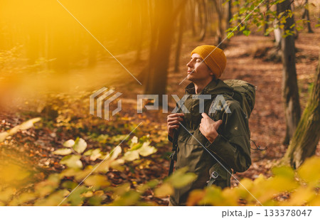 Young Man Traveler Hiking in Autumn Forest Young Man Traveler Hiking in Autumn Forest 133378047