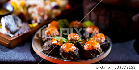 Pumpernickel bread sandwich snack with cured smoked salmon and fresh avocado served as close-up on a wooden cutting board Pumpernickel bread sandwich snack with cured smoked salmon and fresh avocado served as close-up on a wooden cutting board 133378155