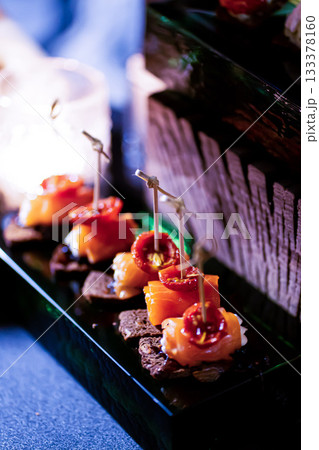 Pumpernickel bread sandwich snack with cured smoked salmon and fresh avocado served as close-up on a wooden cutting board Pumpernickel bread sandwich snack with cured smoked salmon and fresh avocado served as close-up on a wooden cutting board 133378160