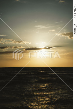 Tranquil Sunset Over the Ocean with Clouded Sky 133378259