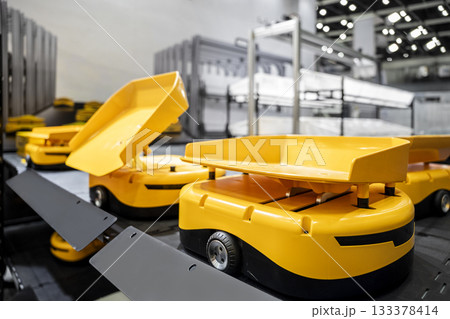 Automatic warehouse robot car carries cardboard box assembly in factory. 133378414
