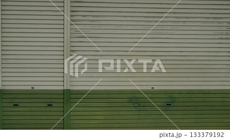 Metal shutter door painted green and white Metal shutter door painted green and white 133379192