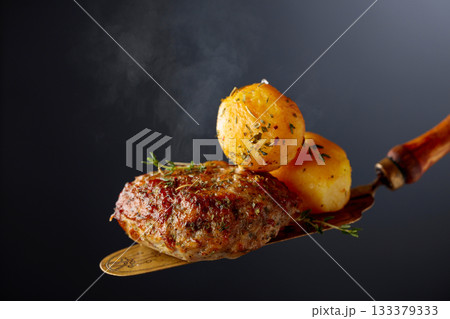 Roasted potatoes with cutlet and thyme. Roasted potatoes with cutlet and thyme. 133379333