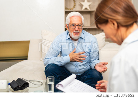 Female doctor examining older senior man in doctor office or at home. Old man patient and doctor have consultation in hospital room. Medicine healthcare medical checkup. Visit to doctor Female doctor examining older senior man in doctor office or at home. Old man patient and doctor have consultation in hospital room. Medicine healthcare medical checkup. Visit to doctor 133379652