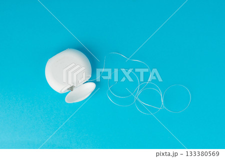 Dental floss plastic container top view. Tooth care string, oral healthcare floss packaging Dental floss plastic container top view. Tooth care string, oral healthcare floss packaging 133380569