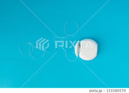 Dental floss plastic container top view. Tooth care string, oral healthcare floss packaging Dental floss plastic container top view. Tooth care string, oral healthcare floss packaging 133380570
