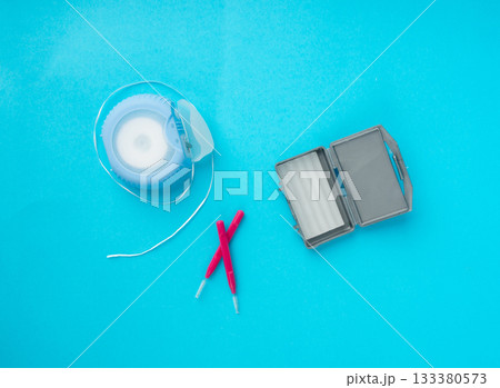 Dental floss, orthodontic wax box and interdental brushes top view. Dental hygiene set 133380573