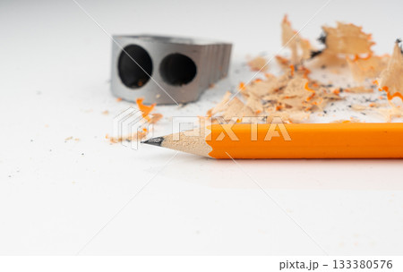 Sharpening pencils. Yellow wooden graphite pencils with erasers, pencil shavings 133380576