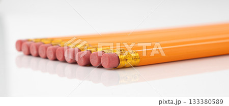 Pencils with a rubber isolated. Unsharpened yellow wooden graphite pencils Pencils with a rubber isolated. Unsharpened yellow wooden graphite pencils 133380589