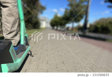 Close up feet on electric scooter Close up feet on electric scooter 133380635