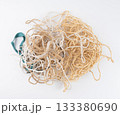 String piece isolated, jute rope fragment, part of packaging cord knots, eco-friendly natural rope 133380690
