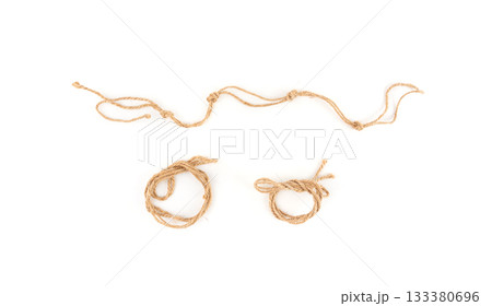 Twine rope piece isolated, jute loop fragment, beige packaging cord knots, old natural line cable 133380696
