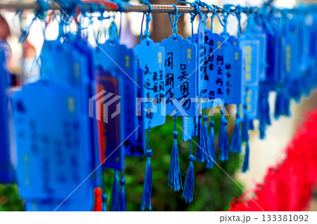 Wooden plaques with Chinese characters and images of dragons, decorated with bright blue tassels Wooden plaques with Chinese characters and images of dragons, decorated with bright blue tassels 133381092