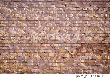 Old red brick wall background. Side illuminated beautiful textured wall 133381198