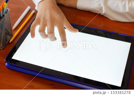 Primary school girl using tablet computer in classroom Primary school girl using tablet computer in classroom 133381278