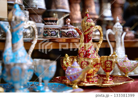 Traditional Bosnian handmade coffee sets on sale. Copper cezves, porcelain cups, and matching accessories. Bascarsija bazaar in Sarajevo. 133381399