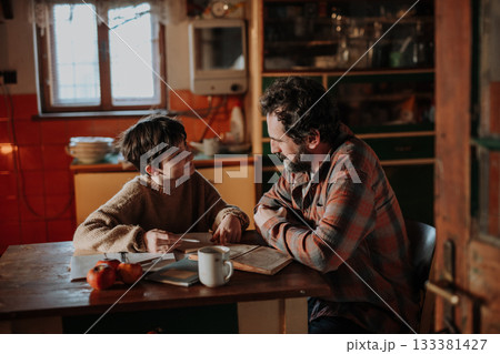 Single mother doing homework with her daughter during hard times. 133381427