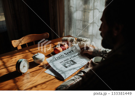 Portrait of poor despaired man sitting at table drinking tea. Portrait of poor despaired man sitting at table drinking tea. 133381449