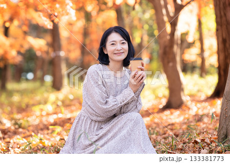 紅葉の公園を散策するミドルの女性 133381773