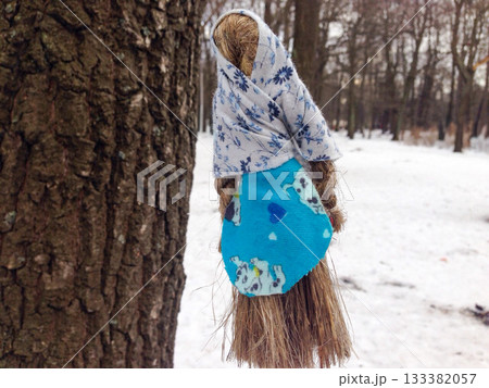 Traditional Slavic Straw Doll Hanging on Tree in Winter Forest Traditional Slavic Straw Doll Hanging on Tree in Winter Forest 133382057
