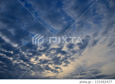 Dark patchy clouds covering blue sky at twilight Dark patchy clouds covering blue sky at twilight 133382477
